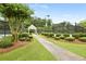 Well-maintained community tennis courts with shaded seating and lush landscaping in a park-like setting at 6655 Grove Meadows Ln, Cumming, GA 30028