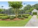 Well-maintained community tennis courts with shaded seating and lush landscaping in a park-like setting at 6655 Grove Meadows Ln, Cumming, GA 30028