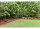 Scenic community walking path through lush woods, perfect for peaceful strolls and enjoying nature at 6655 Grove Meadows Ln, Cumming, GA 30028