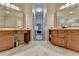 Elegant bathroom featuring dual vanities with beautiful marble countertops and ample storage space at 7512 Portbury Park Ln, Suwanee, GA 30024