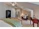 Bright bedroom with sloped ceiling, desk and chair, and adjacent sitting area at 7512 Portbury Park Ln, Suwanee, GA 30024