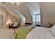 Cozy bedroom featuring a sloped ceiling, natural light, and a workspace at 7512 Portbury Park Ln, Suwanee, GA 30024