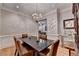Formal dining room with a chandelier, hardwood flooring, and ample space for entertaining at 7512 Portbury Park Ln, Suwanee, GA 30024