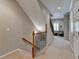 Upstairs hallway with carpet runner, wrought iron banister, and natural light at 7512 Portbury Park Ln, Suwanee, GA 30024