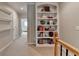 Upstairs hallway features built in bookshelf and access to other rooms at 7512 Portbury Park Ln, Suwanee, GA 30024