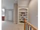 Hallway with a built in bookshelf in a neutrally decorated home at 7512 Portbury Park Ln, Suwanee, GA 30024
