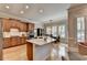 Well-lit kitchen featuring a center island, stainless steel appliances, and ample cabinet space for storage at 7512 Portbury Park Ln, Suwanee, GA 30024