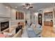Comfortable living room with fireplace, hardwood floors, and stylish furnishings at 7512 Portbury Park Ln, Suwanee, GA 30024