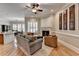 Inviting living room with a fireplace, hardwood floors, and stylish decor offering a cozy ambiance at 7512 Portbury Park Ln, Suwanee, GA 30024