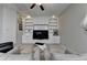 Bright living room featuring custom built-in shelving and comfortable seating at 7512 Portbury Park Ln, Suwanee, GA 30024