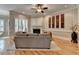 Bright living room with hardwood floors, shutters, and decorative fireplace at 7512 Portbury Park Ln, Suwanee, GA 30024