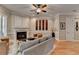 Spacious living room featuring hardwood floors, fireplace, and elegant furnishings at 7512 Portbury Park Ln, Suwanee, GA 30024