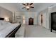 Spacious main bedroom with ceiling fan and double doors to other rooms at 7512 Portbury Park Ln, Suwanee, GA 30024