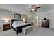 Generous main bedroom featuring a ceiling fan, ensuite bathroom, and walk-in closet at 7512 Portbury Park Ln, Suwanee, GA 30024