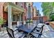 Brick patio featuring an outdoor dining set for six with shade umbrella at 7512 Portbury Park Ln, Suwanee, GA 30024