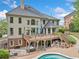 Beautiful back exterior of house with deck, hot tub, and pool for entertaining at 9250 Nesbit Lakes Dr, Alpharetta, GA 30022