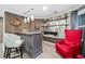 Finished basement bar area with bar seating, open shelving with mirror back and rustic wood accent wall at 9250 Nesbit Lakes Dr, Alpharetta, GA 30022