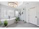 Bright bathroom with a freestanding tub, glass shower, and decorative plants at 9250 Nesbit Lakes Dr, Alpharetta, GA 30022