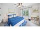 Bright bedroom with blue and white decor, plush carpeting, and a ceiling fan at 9250 Nesbit Lakes Dr, Alpharetta, GA 30022