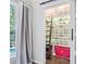 Custom closet featuring clear display cases for shoes, and a rolling ladder for accessibility at 9250 Nesbit Lakes Dr, Alpharetta, GA 30022