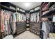 Organized walk-in closet with ample hanging space, shelving, drawers and good lighting at 9250 Nesbit Lakes Dr, Alpharetta, GA 30022