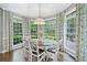Bright dining area with views of backyard, classic table and chairs, and stylish drapery at 9250 Nesbit Lakes Dr, Alpharetta, GA 30022