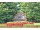 Stone entrance sign for Nesbit Lakes community surrounded by colorful flowers and greenery at 9250 Nesbit Lakes Dr, Alpharetta, GA 30022