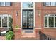 Elegant front entrance featuring a double door, brick pillars, and decorative lighting at 9250 Nesbit Lakes Dr, Alpharetta, GA 30022
