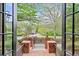 A view through the front door frames a landscaped yard and charming brick entryway at 9250 Nesbit Lakes Dr, Alpharetta, GA 30022