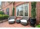 Inviting front porch with comfortable seating, planters, and classic brick flooring at 9250 Nesbit Lakes Dr, Alpharetta, GA 30022