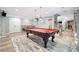 Spacious game room with a pool table, stylish rug, and neutral wall color at 9250 Nesbit Lakes Dr, Alpharetta, GA 30022