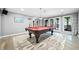 Spacious game room with a pool table, stylish rug, and French doors to the outside at 9250 Nesbit Lakes Dr, Alpharetta, GA 30022