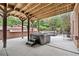 Relaxing outdoor hot tub on a covered patio, perfect for enjoying the surrounding nature at 9250 Nesbit Lakes Dr, Alpharetta, GA 30022