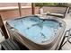 Inviting hot tub with clear water, surrounded by comfortable seating and lush landscaping at 9250 Nesbit Lakes Dr, Alpharetta, GA 30022