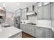 Well-lit kitchen with stainless steel appliances, gray cabinets, and stone countertops at 9250 Nesbit Lakes Dr, Alpharetta, GA 30022