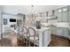Stylish kitchen featuring a large island with seating, modern appliances, and ample cabinetry at 9250 Nesbit Lakes Dr, Alpharetta, GA 30022