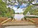 Scenic view of a lake with a gazebo and steps leading down to the water at 9250 Nesbit Lakes Dr, Alpharetta, GA 30022
