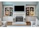 Living room with fireplace, built-in shelving, and neutral decor at 9250 Nesbit Lakes Dr, Alpharetta, GA 30022