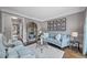 Comfortable living room with blue sofa, neutral paint, and sophisticated decor at 9250 Nesbit Lakes Dr, Alpharetta, GA 30022
