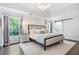 Elegant main bedroom with dark hardwood floors and a view of the outdoors at 9250 Nesbit Lakes Dr, Alpharetta, GA 30022
