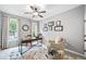 Comfortable home office space with natural light, ceiling fan, and a decorative floral rug at 9250 Nesbit Lakes Dr, Alpharetta, GA 30022