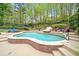 Landscaped pool with a waterslide, surrounded by lush greenery and comfortable lounge chairs at 9250 Nesbit Lakes Dr, Alpharetta, GA 30022