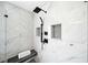 Sleek walk-in shower with marble-like tiles, a bench, and rainfall showerhead at 9250 Nesbit Lakes Dr, Alpharetta, GA 30022