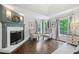 Cozy sitting area with fireplace, hardwood floors, and ample natural light at 9250 Nesbit Lakes Dr, Alpharetta, GA 30022