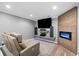 Finished basement with a home theater setup featuring a large screen, speakers, and a modern fireplace at 9250 Nesbit Lakes Dr, Alpharetta, GA 30022