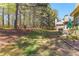 Wide-open backyard with lush green lawn and mature trees at 116 Edgeview Ct, Dallas, GA 30157