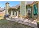 Cozy backyard featuring a concrete patio with rocking chairs, string lights and a grill at 116 Edgeview Ct, Dallas, GA 30157
