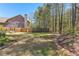 Open backyard with a wood fence that backs up to a treeline at 116 Edgeview Ct, Dallas, GA 30157