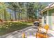 Cozy backyard featuring a concrete patio with rocking chairs, string lights and a grill at 116 Edgeview Ct, Dallas, GA 30157