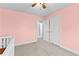 The additional bedroom is carpeted, with neutral colored walls and a ceiling fan at 116 Edgeview Ct, Dallas, GA 30157